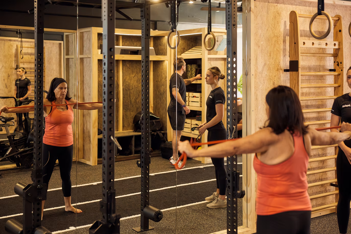 Client using resistance band with coaching support at AHP studio